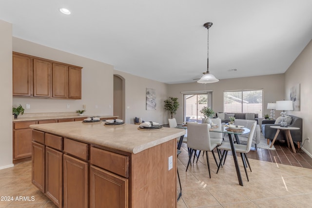 kitchen featuring pendant lighting, a kitchen island, and light tile patterned floors