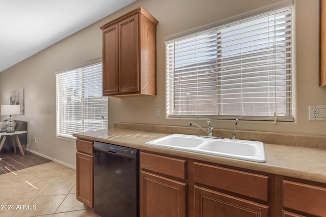 kitchen featuring sink, light tile patterned floors, and black dishwasher