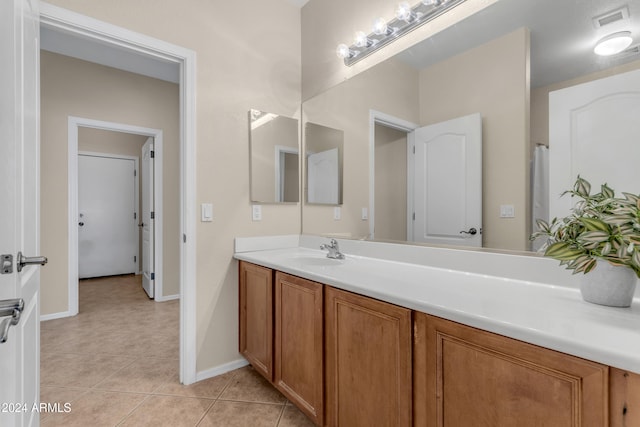 bathroom with tile patterned flooring and vanity