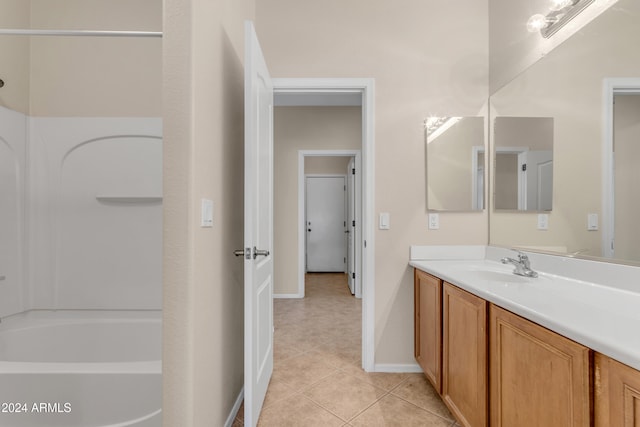 bathroom featuring washtub / shower combination, vanity, and tile patterned floors