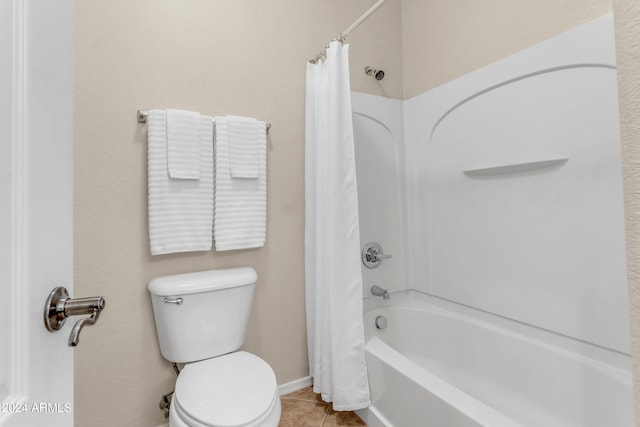 bathroom with tile patterned floors, shower / bath combo, and toilet