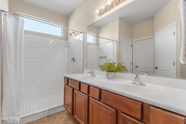 bathroom featuring tile patterned flooring, vanity, and curtained shower