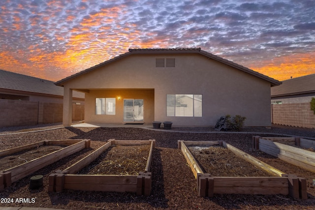 view of back house at dusk