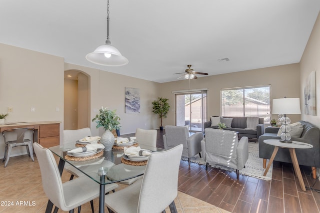 dining space with ceiling fan and dark hardwood / wood-style flooring