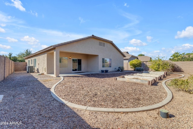 back of property with cooling unit and a patio area