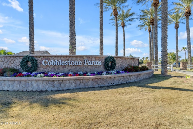 community / neighborhood sign with a lawn