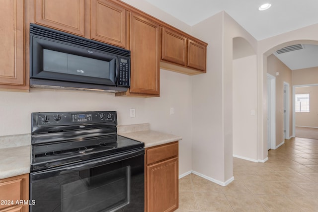 kitchen with black appliances and light tile patterned floors