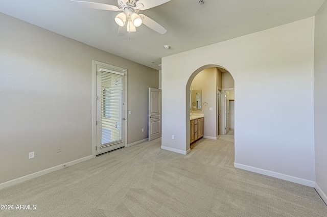 carpeted spare room with ceiling fan