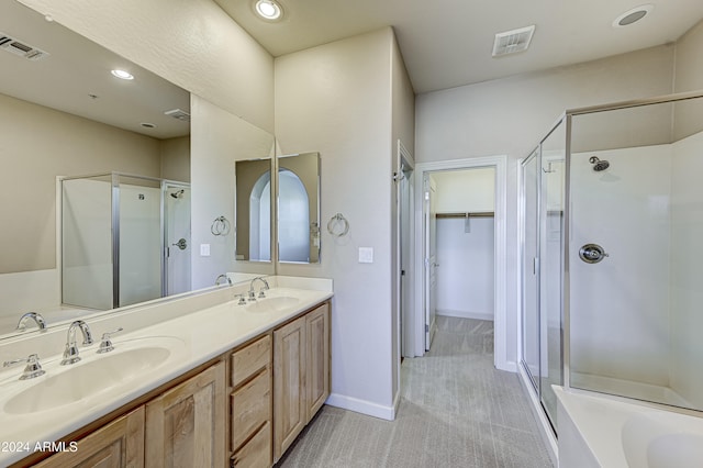 bathroom with vanity and independent shower and bath