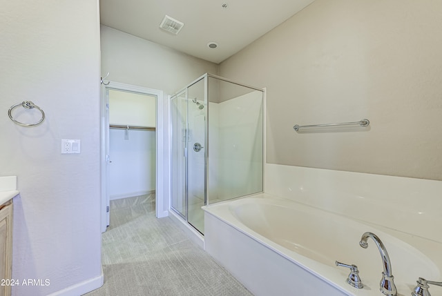 bathroom featuring vanity and separate shower and tub