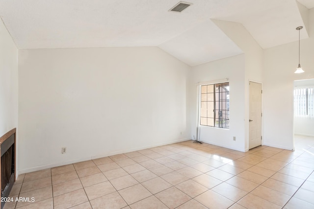 tiled spare room with a wealth of natural light and vaulted ceiling