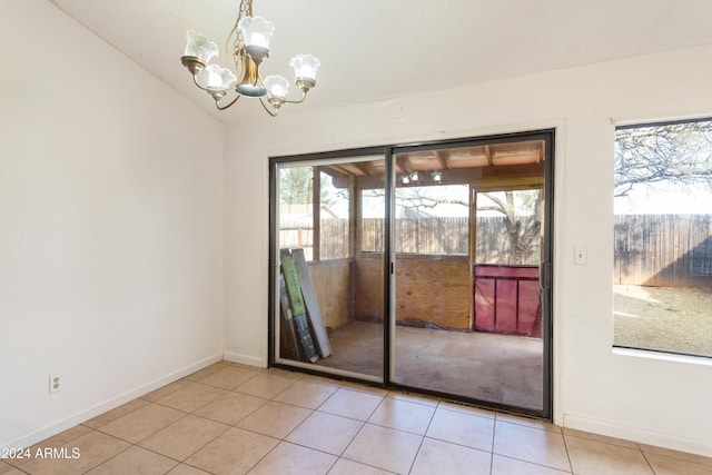 doorway with a chandelier, lofted ceiling, and light tile patterned flooring