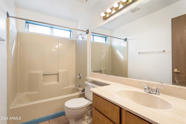 full bathroom featuring washtub / shower combination, tile patterned floors, vanity, and toilet