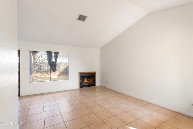 unfurnished living room with light tile patterned floors and vaulted ceiling