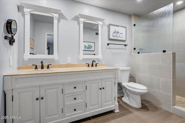 9450 N 94th Pl Unit 106, Scottsdale, AZ 85258 - full bath with tiled shower, double vanity, toilet, and wood tiled floors