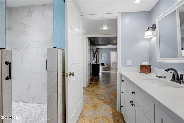 9450 N 94th Pl Unit 106, Scottsdale, AZ 85258 - bathroom with vanity, a marble finish shower, and recessed lighting