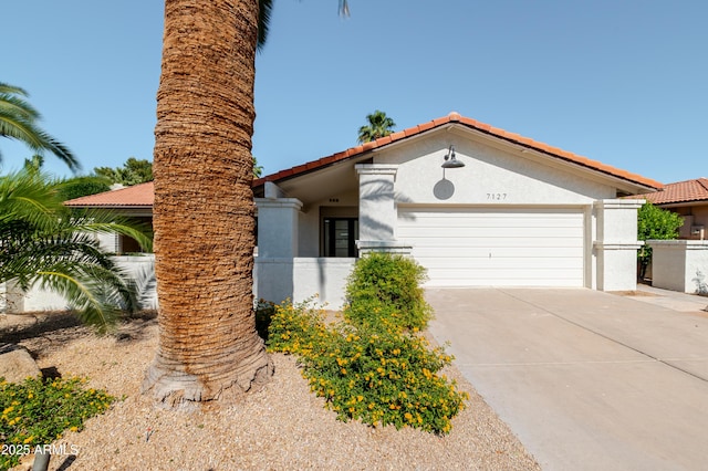 7127 N 79th St, Scottsdale, AZ 85258 - mediterranean / spanish-style house featuring a garage, stucco siding, driveway, and a tile roof