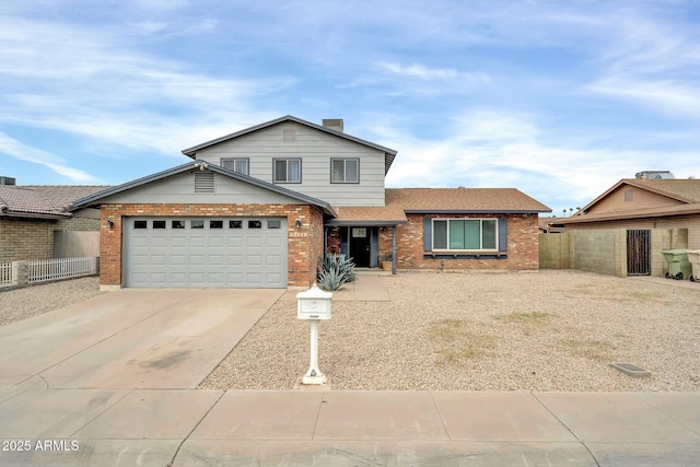 traditional-style home featuring an attached garage, fence, concrete driveway, and brick siding