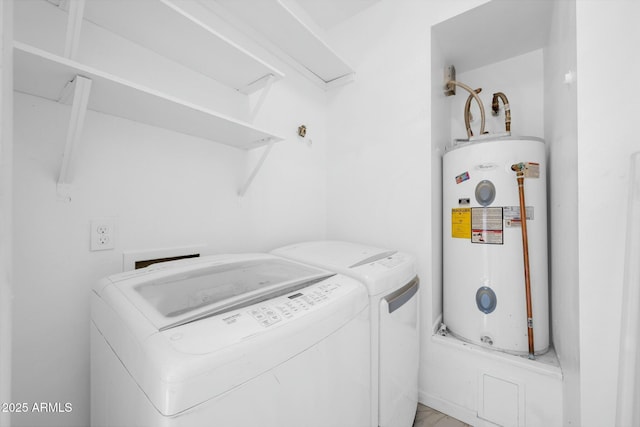 washroom with washing machine and dryer, laundry area, and water heater