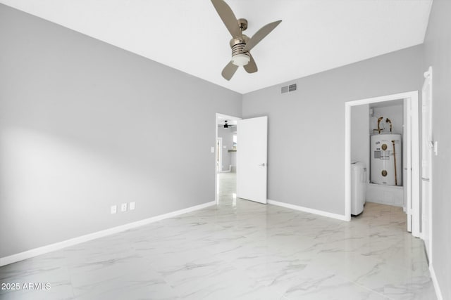 unfurnished bedroom with marble finish floor, visible vents, baseboards, and water heater