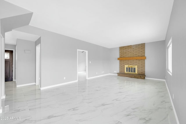 unfurnished living room featuring marble finish floor, a fireplace, and baseboards