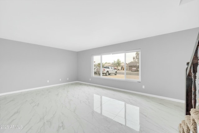 interior space featuring marble finish floor and baseboards