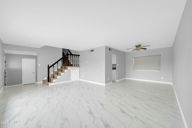 unfurnished living room featuring baseboards, visible vents, ceiling fan, stairway, and marble finish floor