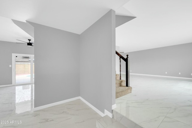 stairway featuring lofted ceiling, marble finish floor, a ceiling fan, and baseboards