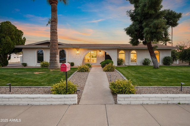 ranch-style house featuring a lawn