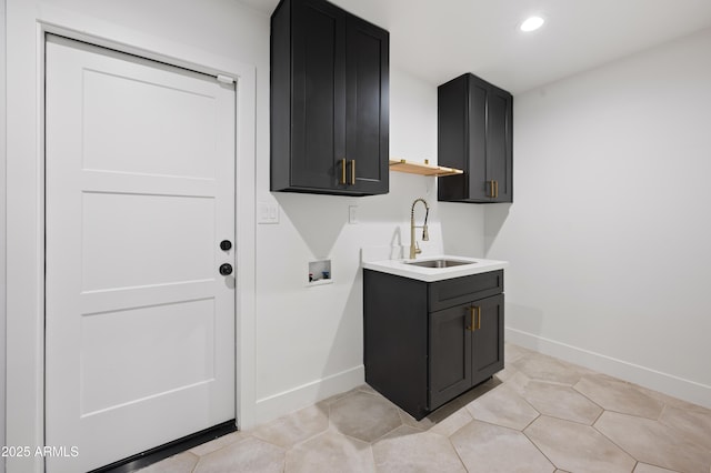 laundry area featuring light tile patterned flooring, cabinets, hookup for a washing machine, and sink