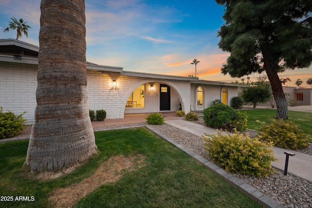 ranch-style house featuring a lawn