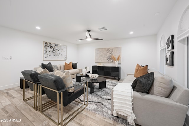 living room with light hardwood / wood-style flooring and ceiling fan