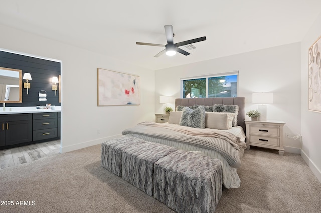 carpeted bedroom featuring ceiling fan and ensuite bathroom