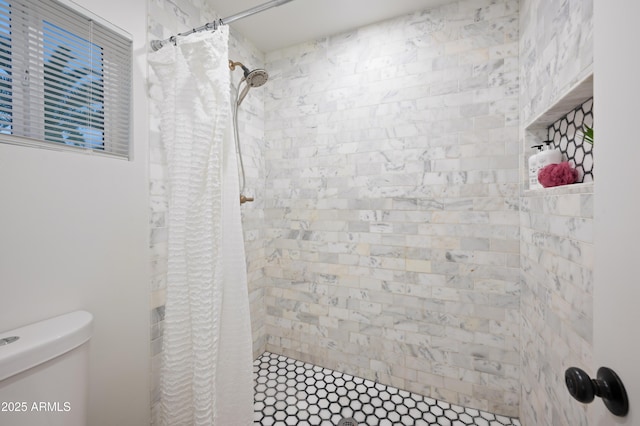 bathroom featuring toilet and a shower with shower curtain