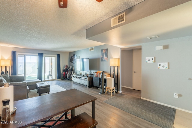 602 E Colgate Dr, Tempe, AZ 85283 - living area featuring a textured ceiling, baseboards, and light wood-style flooring