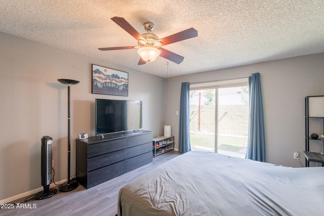 602 E Colgate Dr, Tempe, AZ 85283 - bedroom featuring access to outside, wood finished floors, a textured ceiling, a ceiling fan, and baseboards