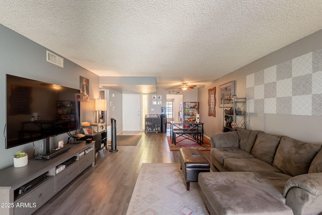 602 E Colgate Dr, Tempe, AZ 85283 - living room featuring wood finished floors, a textured ceiling, and a ceiling fan