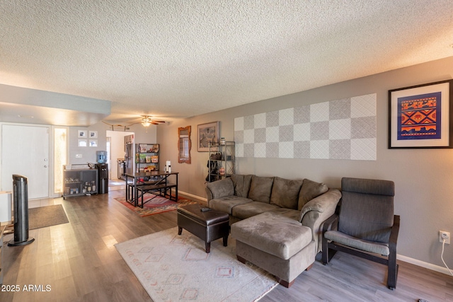 602 E Colgate Dr, Tempe, AZ 85283 - living room featuring a textured ceiling, wood finished floors, baseboards, and a ceiling fan