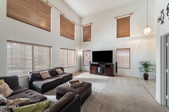 living room with light carpet and a towering ceiling