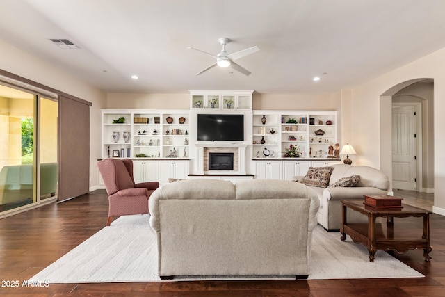 2457 E Melrose St, Mesa, AZ 85213 - living room featuring a ceiling fan, arched walkways, dark wood-style floors, recessed lighting, and a glass covered fireplace