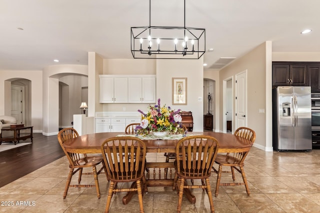 2457 E Melrose St, Mesa, AZ 85213 - dining area featuring arched walkways, recessed lighting, a chandelier, light tile patterned floors, and baseboards
