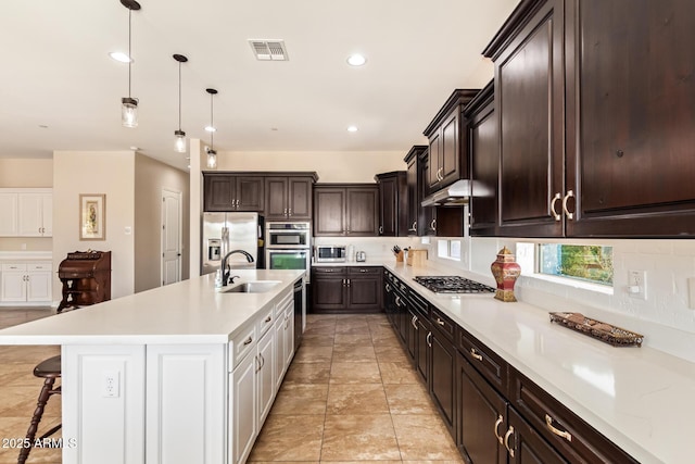 2457 E Melrose St, Mesa, AZ 85213 - kitchen with appliances with stainless steel finishes, a sink, light countertops, dark brown cabinetry, and recessed lighting