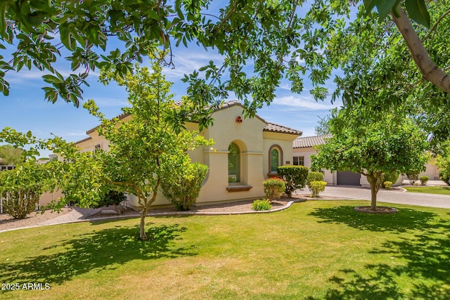 2457 E Melrose St, Mesa, AZ 85213 - mediterranean / spanish-style house with a tile roof, stucco siding, driveway, and a front yard