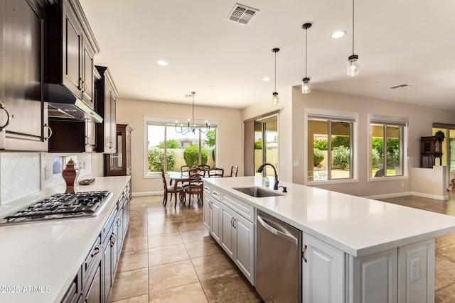 2457 E Melrose St, Mesa, AZ 85213 - kitchen featuring stainless steel appliances, a sink, baseboards, tasteful backsplash, and under cabinet range hood