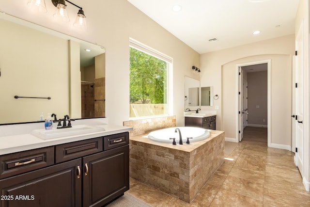 2457 E Melrose St, Mesa, AZ 85213 - bathroom featuring two vanities, a bath, a tile shower, and recessed lighting