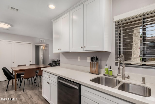 6480 N 82nd St Unit 1136, Scottsdale, AZ 85250 - kitchen with dishwasher, a sink, light countertops, white cabinetry, and light wood finished floors