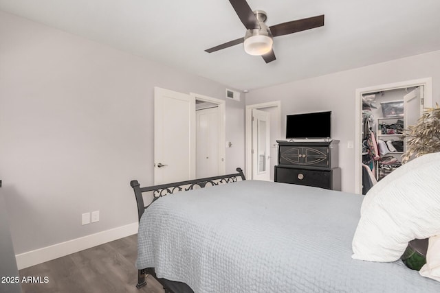 6480 N 82nd St Unit 1136, Scottsdale, AZ 85250 - bedroom featuring wood finished floors, baseboards, a closet, a walk in closet, and ceiling fan