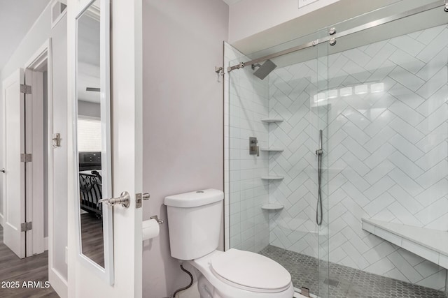 6480 N 82nd St Unit 1136, Scottsdale, AZ 85250 - full bathroom featuring toilet, a stall shower, and wood finished floors