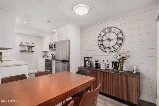 6480 N 82nd St Unit 1136, Scottsdale, AZ 85250 - kitchen with appliances with stainless steel finishes, a sink, white cabinetry, recessed lighting, and light wood-style flooring