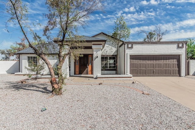 6701 W Monterey Way, Phoenix, AZ 85033 - view of front facade with a garage, concrete driveway, and stucco siding